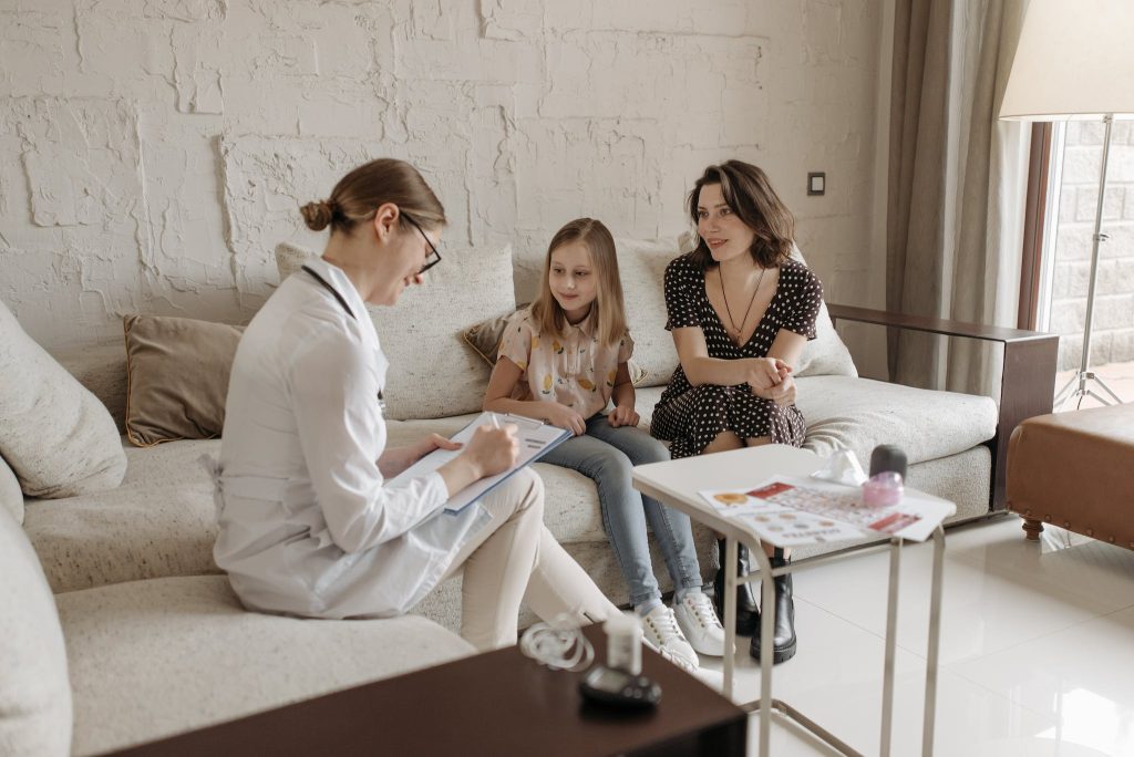 A Doctor in a Consultation with a Mother and Her Daughter